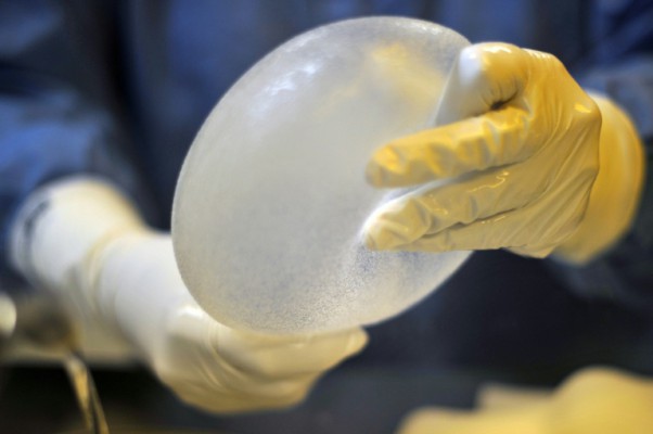 AFP  File  Christophe SimonA technician works on a breast prosthesis at a Silimed factory on the outskirts of Rio de Janeiro Brazil