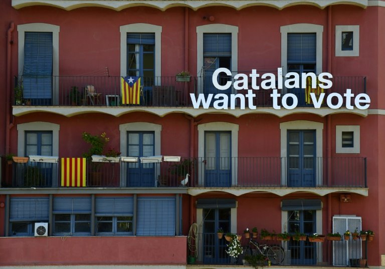 Pro-independence Catalan flags and a sign reading