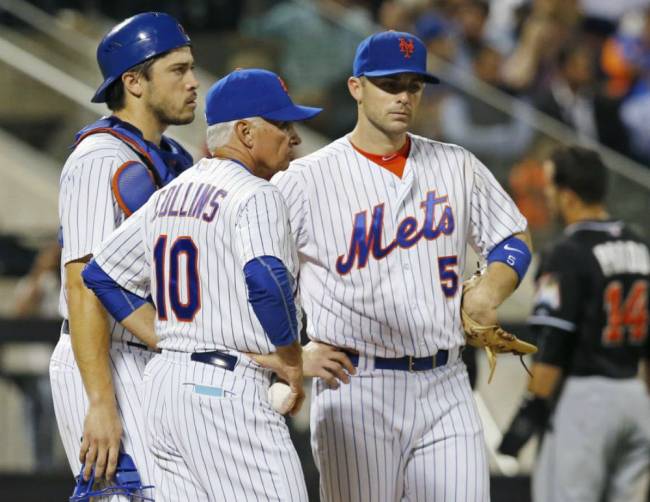 Mets catcher Travis d'Arnaud manager Terry Collins and third baseman David Wright wait on the mound during a sixth-inning pitching change