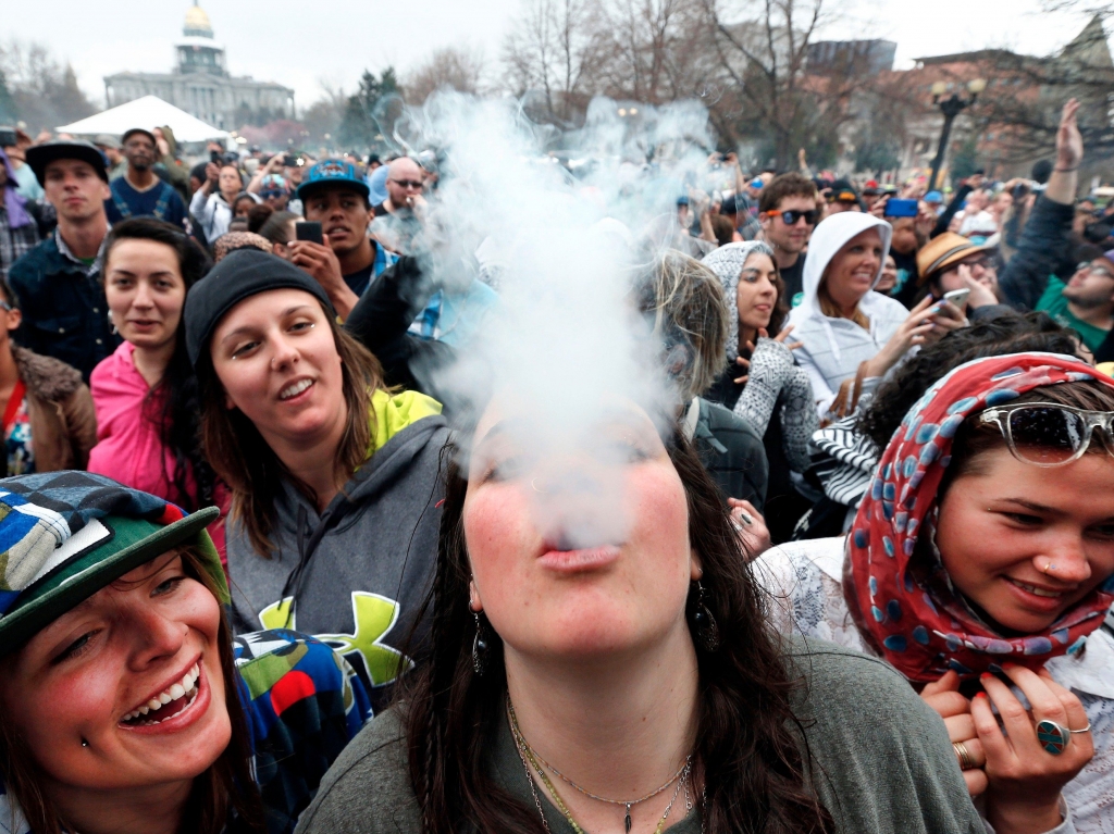 Partygoers dance and smoke pot on the first of two days at the annual 4/20 marijuana festival in Denver