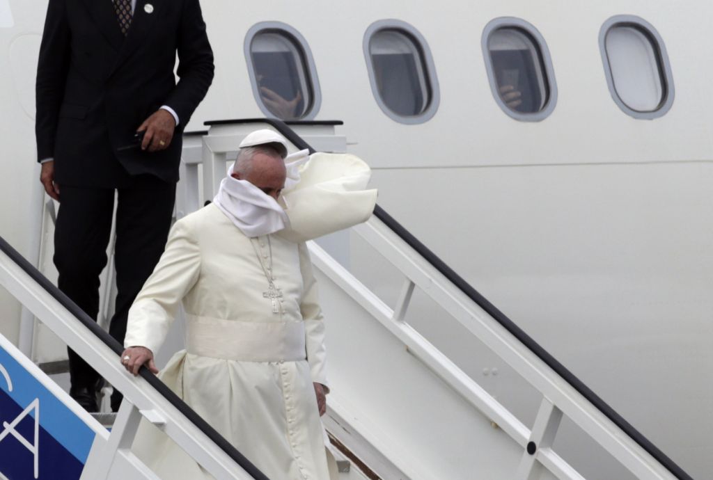 AP press Pope Francis looses his hat as he was greeted by a strong wind when he arrived in Cuba earlier today