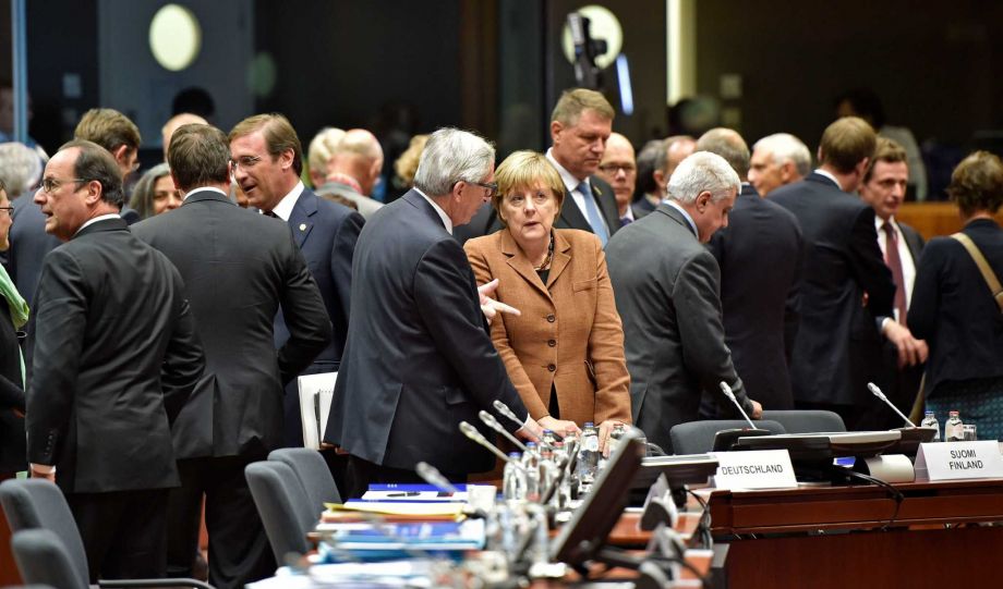 German Chancellor Angela Merkel center right listens to European Commission President Jean Claude Juncker, center left as they arrive for an emergency EU heads of state summit on the migrant crisis at the EU Commission headquarters in Brussels on Wed