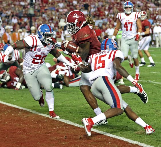 Derrick Henry center carries the ball in for a touchdown between Mississippi linebacker Christian Russell left and defensive back Kendarius Webster right during the second half of an NCAA college football game Saturday