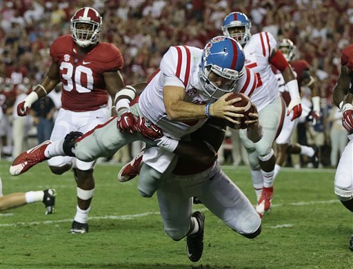 Mississippi quarterback Chad Kelly dives in for a touchdown against Alabama linebacker Shaun Hamilton during first half of an NCAA college football game Saturday Sept. 19 2015 in Tuscaloosa Ala