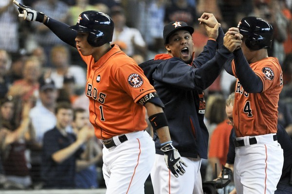 Carlos Correa #1 of the Houston Astros celebrates his two-run home run with Carlos Gomez and George Springer #4 during the third inning against the Texas Rangers at Minute Maid Park