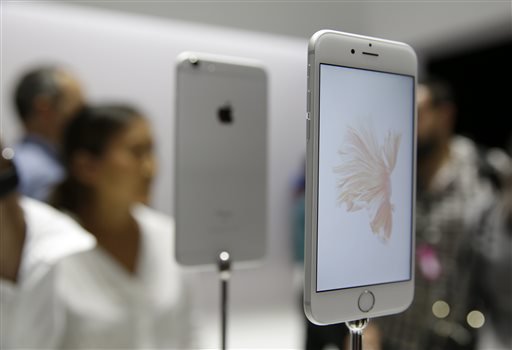 People look over the new Apple iPhone 6s models during a product display following an Apple event Wednesday Sept. 9 2015 in San Francisco. Apple staked a new claim to the living room on Wednesday as the maker of iPhones and other hand-held gadgets unv