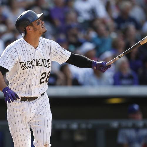 Nolan Arenado follows the flight of his three-run home run off Los Angeles Dodgers starting pitcher Alex Wood in the fourth inning of a baseball game Sunday Sept. 27 2015 in Denver