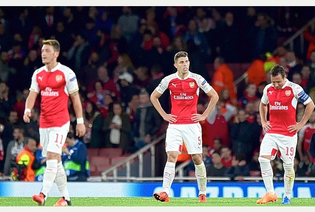 Arsenal are dejected after they concede a third goal against Olympiakos during the Champions League match at the Emirates