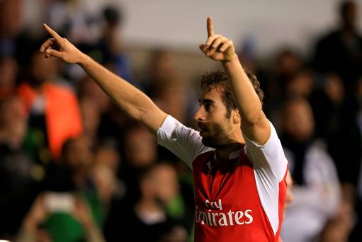 Arsenal's Mathieu Flamini celebrates scoring his side's second goal of the game during the Capital One Cup third round match at White Hart Lane London