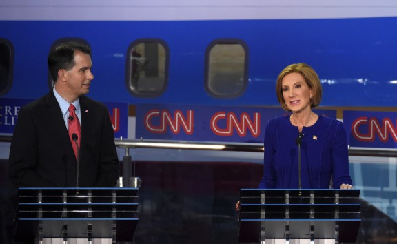 Carly Fiorina speaks as Wisconsin Gov. Scott Walker listens during the CNN Republican presidential debate