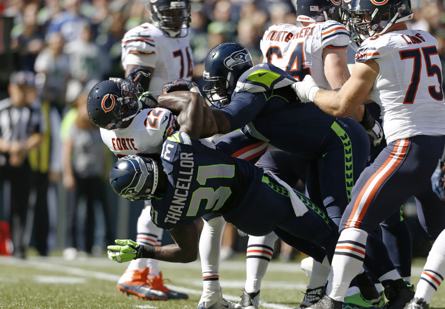 Seattle Seahawks strong safety Kam Chancellor and defensive tackle Ahtyba Rubi tackle Bears running back Matt Forte in the first half Sunday in Seattle