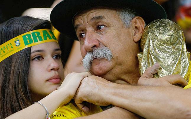 Brazilian fans react to their team's loss at the end of their 2014 World Cup semi-finals against Germany