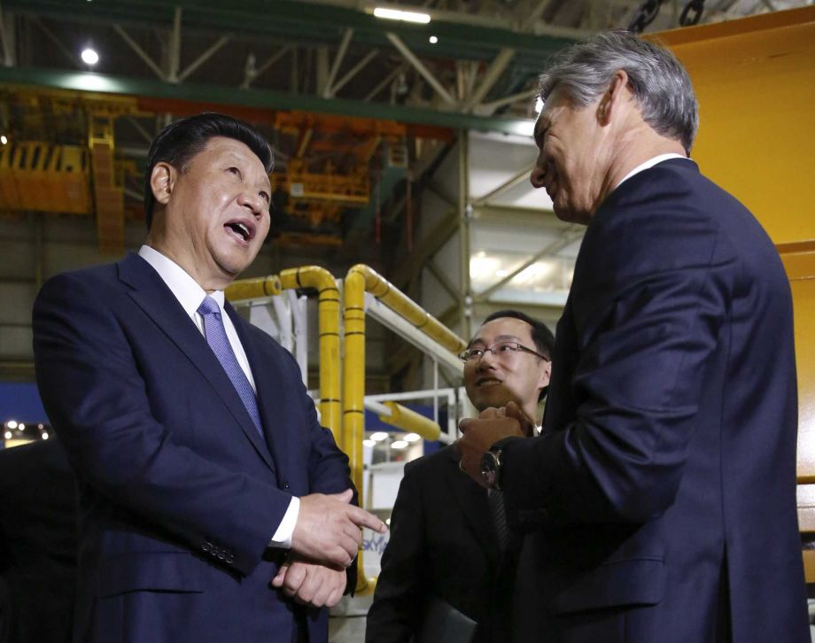 Chinese President Xi Jinping left and president and CEO Boeing Commercial Airplanes Ray Conner talk while touring the Boeing assembly line Wednesday Sept. 23 2015 in Everett Wash. Boeing has agreed to buy about 300 jets from Boeing. In addition