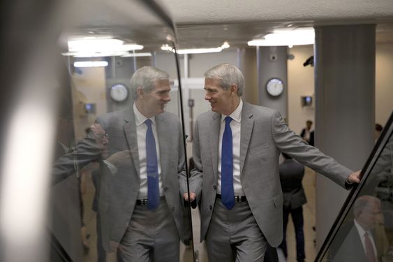 Sen. Rob Portman R Ohio looks toward a reporter on the other side of a glass railing as he ascends the escalator on Capitol Hill in Washington. A temporary government-wide funding measure that would keep the governme