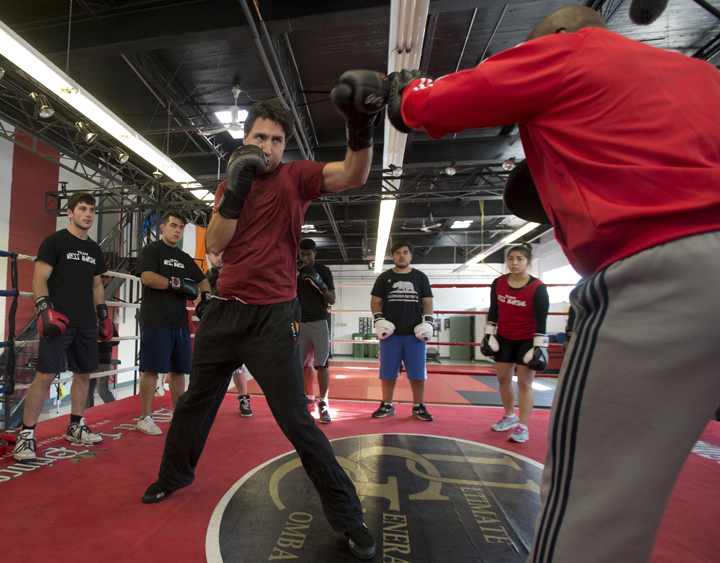 Liberal leader Justin Trudeau boxes with trainer Ali Nestor during a campaign stop in Montreal Wednesday