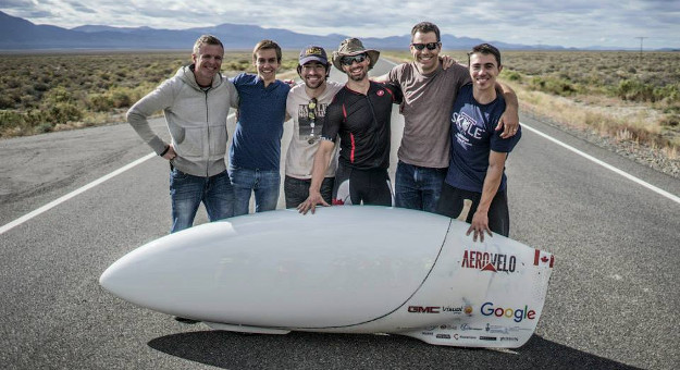 The world’s fastest human Dr. Todd Reichert, with Aero Velo co-founder Cameron Robertson, and the rest of the team posing with their world record setting speedbike Eta at the 2015 World Human Powered Speed Challenge in Batt