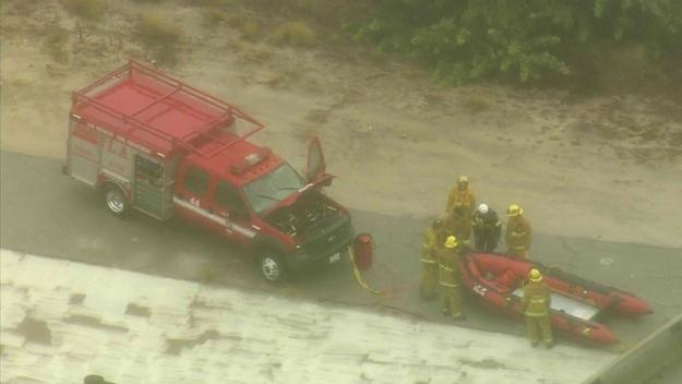 Crews worked to rescue one person and a dog from the Los Angeles River near the NB 2 Freeway at Fletcher Drive in Atwater Village