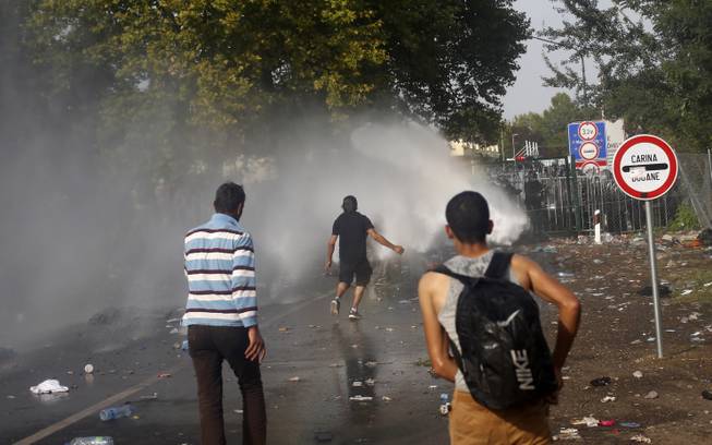 Hungary uses tear gas, water cannons on refugees trying to cross border