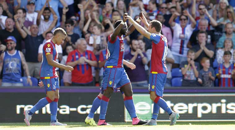 Crystal Palace players celebrate with their star midfielder Bakary Sako during one of his recent goals