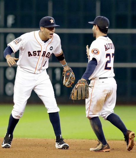 Houston Astros Carlos Correa and Jose Altuve celebrate their 4-2 win over the Texas Rangers in a baseball game Sunday Sept. 27 2015 in Houston