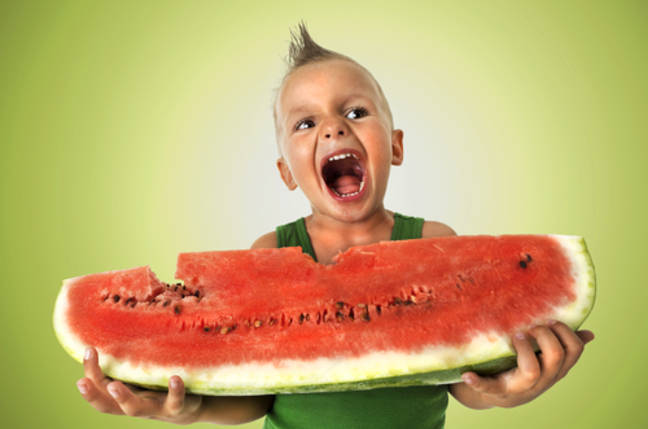 Boy slurps watermelon. Credit Shutterstock