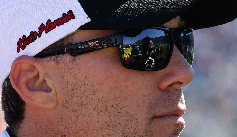 Driver Kevin Harvick defending NASCAR Sprint Cup Series champion listens to a crew member Sunday in Joliet Ill