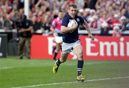 Scotland's Mark Bennett runs and goes on to score a try during the Rugby World Cup Pool B match between Scotland and Japan at Kingsholm Gloucester England Wednesday Sept. 23 2015