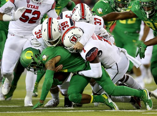 Oregon wide receiver Charles Nelson is brought down by Utah defenders during the second half of an NCAA college football game Saturday Sept. 26 2015 in Eugene Ore