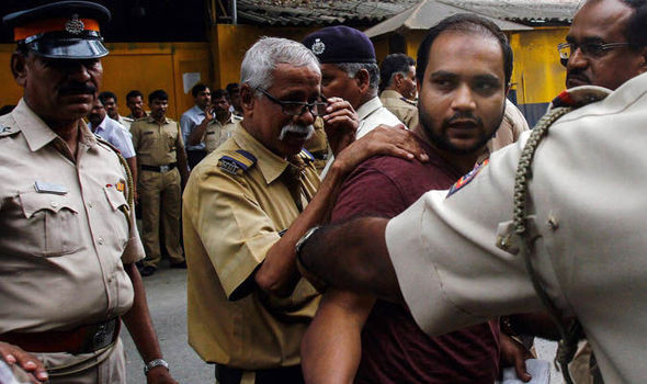 Police escort one of the defendants away