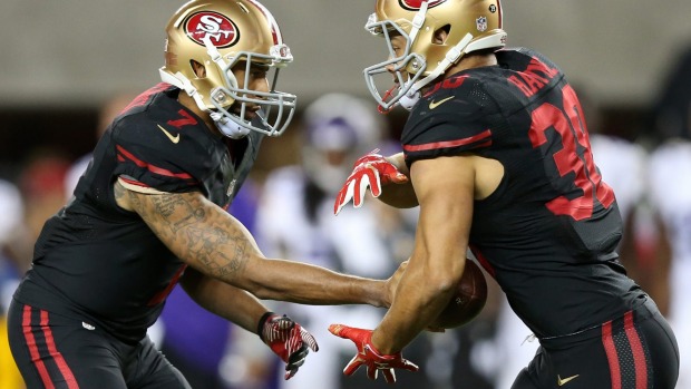 On the charge Colin Kaepernick hands the ball off to Jarryd Hayne