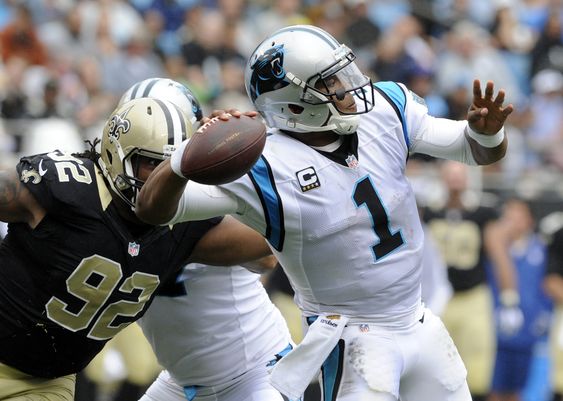 Newton looks to pass under pressure from New Orleans Saints John Jenkins in the second half of an NFL football game in Charlotte N.C. Sunday Sept. 27 2015