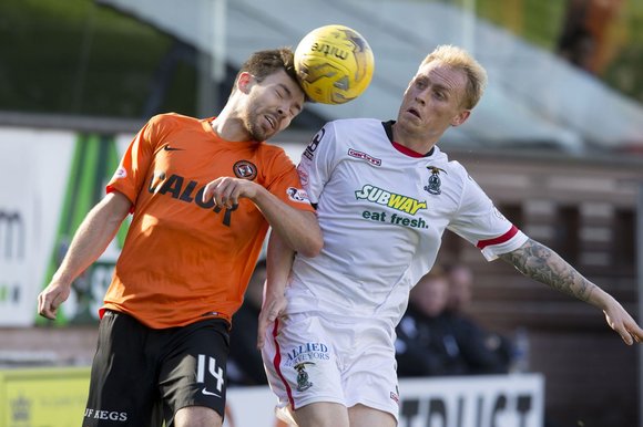 Head to head Ryan Dow contests for the ball with Inverness CT’s Carl Tremarco