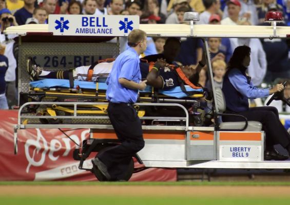 Milwaukee Brewers third baseman Elian Herrera is carted