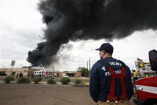 Firefighters battle a three-alarm hazmat fire at 1850 W. Broadway Wednesday Sept. 9 2015 in Phoenix. Firefighters have gained control over a three-alarm hazmat fire at a solvent recycling company that blackened the sky south of downtown Phoenix for mor