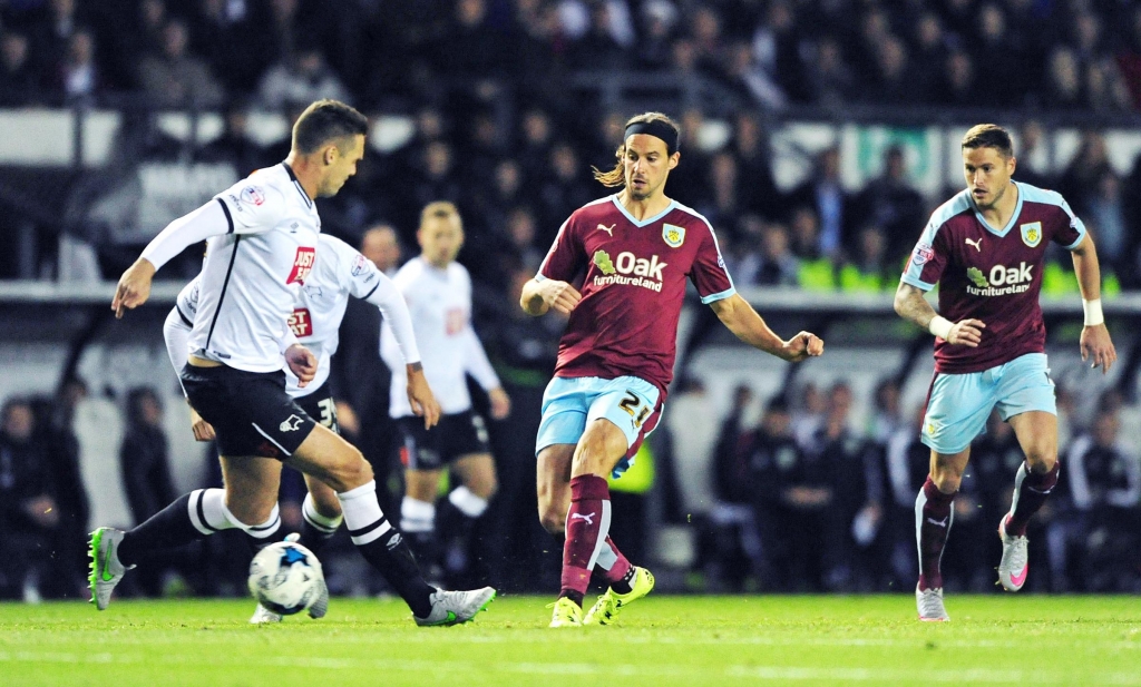 Former Burnley defender Jason Shackell attempts to tackle George Boyd