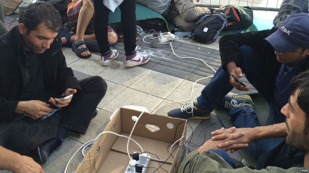 Outside Vienna train station aid workers provide what many refugees want most electricity to charge mobile phones that kept them alive and on track so far Sept. 15 2015