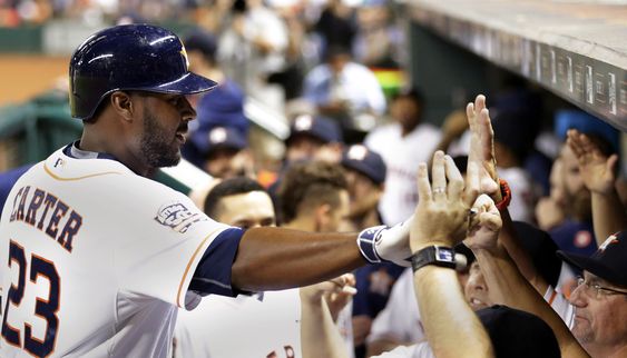 Carter is congratulated as he returns to the dugout after hitting a home run against the Los Angeles Angels during the second inning of a baseball game Tuesday Sept. 22 2015 in Houston