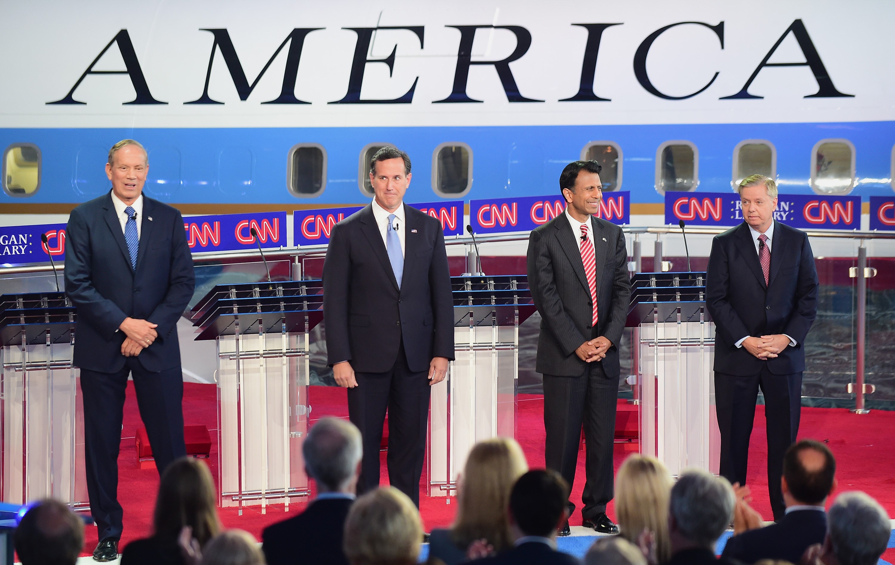 Republican presidential hopefuls George Pataki Rick Santorum Bobby Jindal and Lindsey Graham participate in the Republican'Happy Hour debate