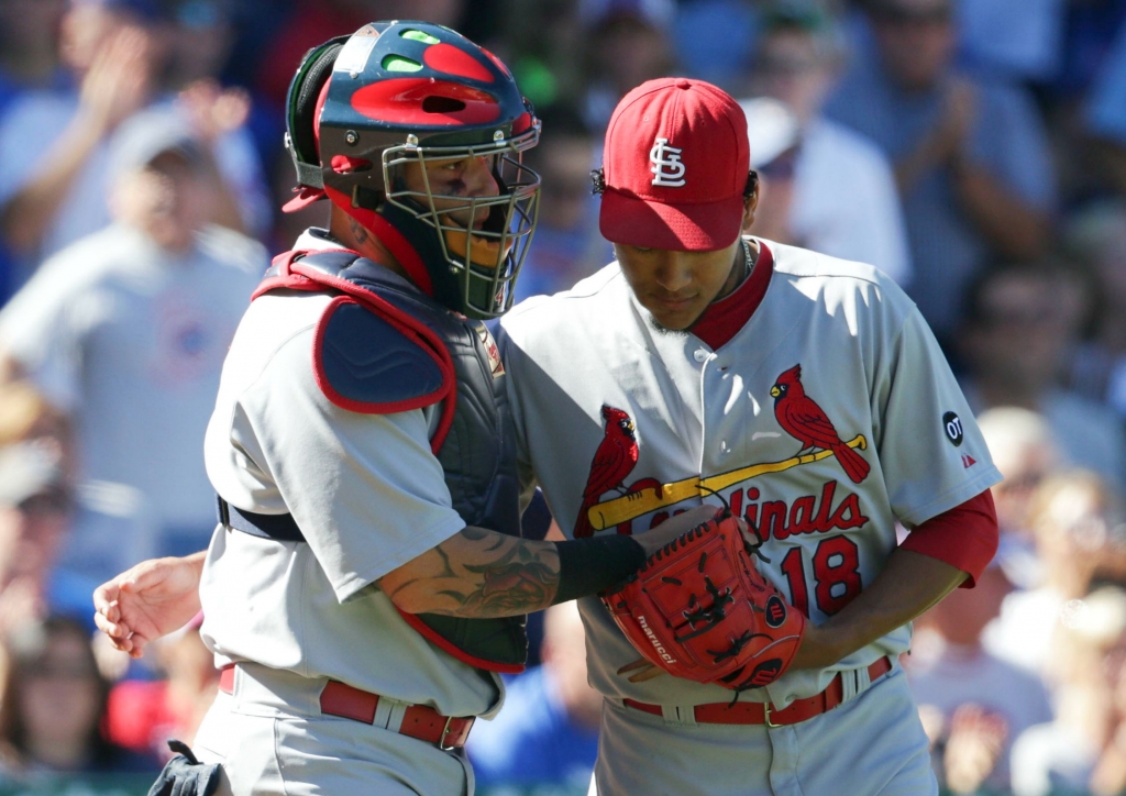 Carlos Martinez #18 of the St. Louis Cardinals talks with catcher Yadier Molina #4 of the St. Louis Cardinals at Wrigley Field