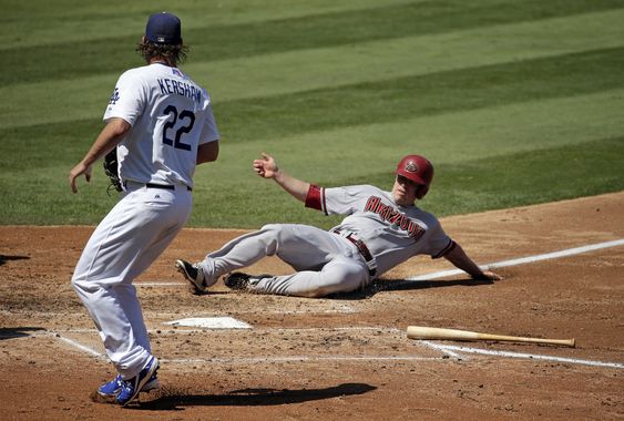 Hill right scores past Los Angeles Dodgers starting pitcher Clayton Kershaw on a single on Paul Goldschmidt during the third inning of a baseball game in Los Angeles Thursday Sept. 24 2015