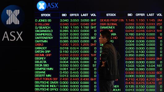 A man monitors trading on the electronic screens at the Australian Stock Exchange in Sydney