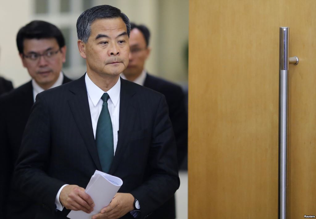 FILE- Hong Kong Chief Executive Leung Chun-ying arrives at a news conference which was held as part of the National People's Congress the country's parliament in Beijing