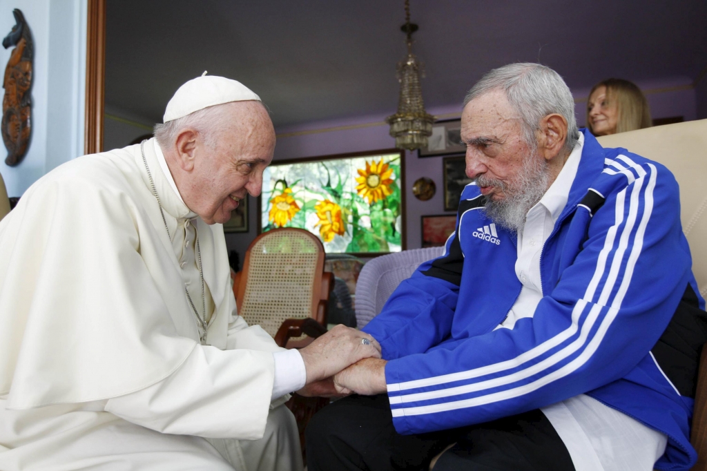 Pope Francis and former Cuban President Fidel Castro hold hands at Castro's residence in Havana Sept. 20