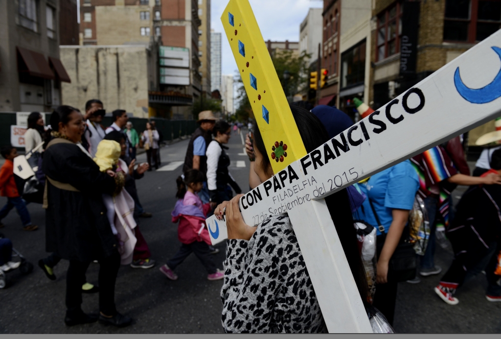 Pilgrim carries cross at mass Sinai Flores of Kansas City Mo. carries the cross of her diocese to get it blessed by Pope Francis during the public mass in Philadelphia