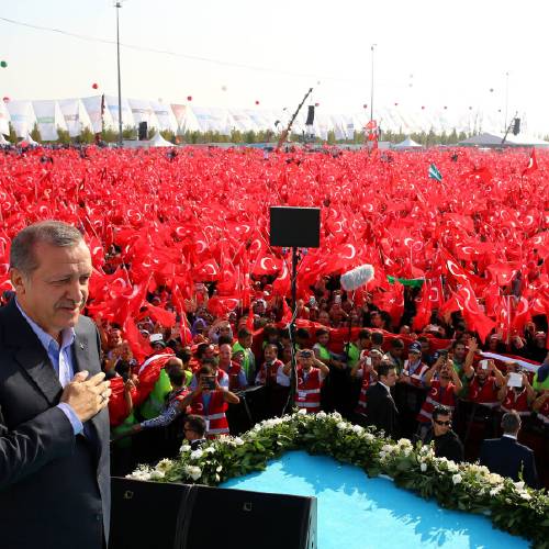 Recep Tayyip Erdogan salutes supporters as tens of thousands of flag-waving demonstrators rally to denounce violence by Kurdish rebels in Istanbul Turkey Sunday Sept. 20 2015. Speakers condemned terrorism and the viole