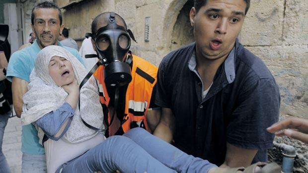 A Palestinian woman affected by tear gas is evacuated by medics during clashes between stone-throwing Palestinians and Israeli police in Jerusalem’s Old City