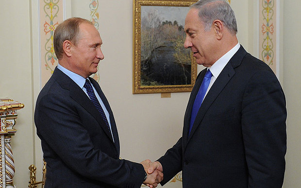 Russian President Vladimir Putin shakes hands with Israeli Prime Minister Benjamin Netanyahu during a meeting at the Novo Ogaryovo residence outside Moscow