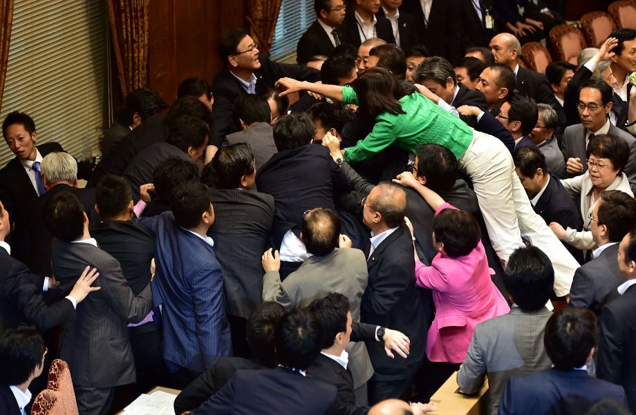 Ruling and opposition lawmakers in Japan’s upper house scuffle at a committee session on contentious security bills