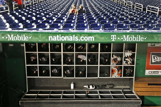 Fans sit in stands as rain falls before a baseball game between the Washington Nationals and the Baltimore Orioles at Nationals Park Monday Sept. 21 2015 in Washington. The game was postponed and is to be played Thursday Sept. 24. (AP