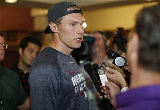 Colorado Avalanche defenseman Erik Johnson talks to reporters as players report for the first day of NHL hockey training camp Thursday Sept. 17 2015 in Denver. Players will take to the ice Friday for practice sessions to kick off the 2015-16 season